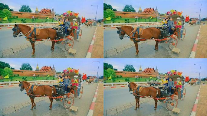 在泰国南邦的phrathi Lampang Luang寺庙享受马车之旅的家庭