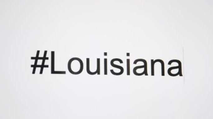 一个人在他们的计算机屏幕上键入 “# Louisiana”，然后使用州缩写