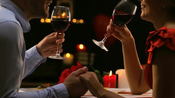 恋爱中的情侣聊天喝红酒，舒适的情人节庆祝活动