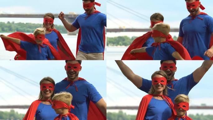 幸福的家庭打扮得像超级英雄，支持父母站在儿子后面