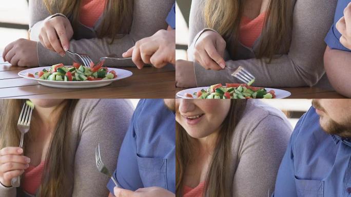 快乐肥胖的男人和女人在户外吃新鲜蔬菜沙拉，减肥