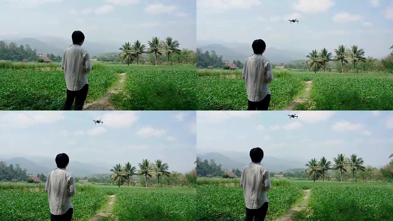 使用无人机遥控器的亚洲男子农民飞行员