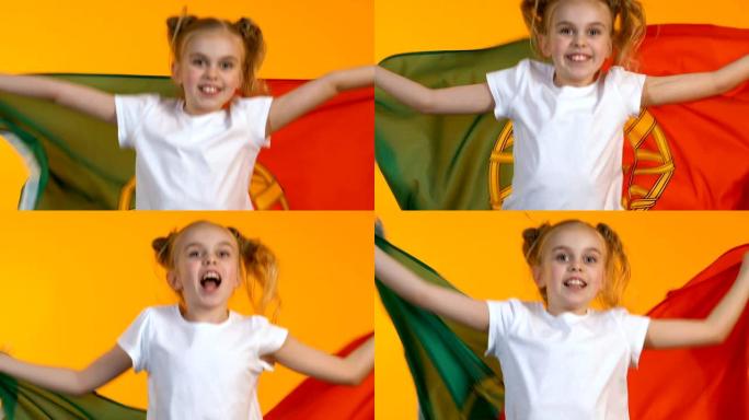 小女孩挥舞着葡萄牙小球迷的旗帜为国家队加油