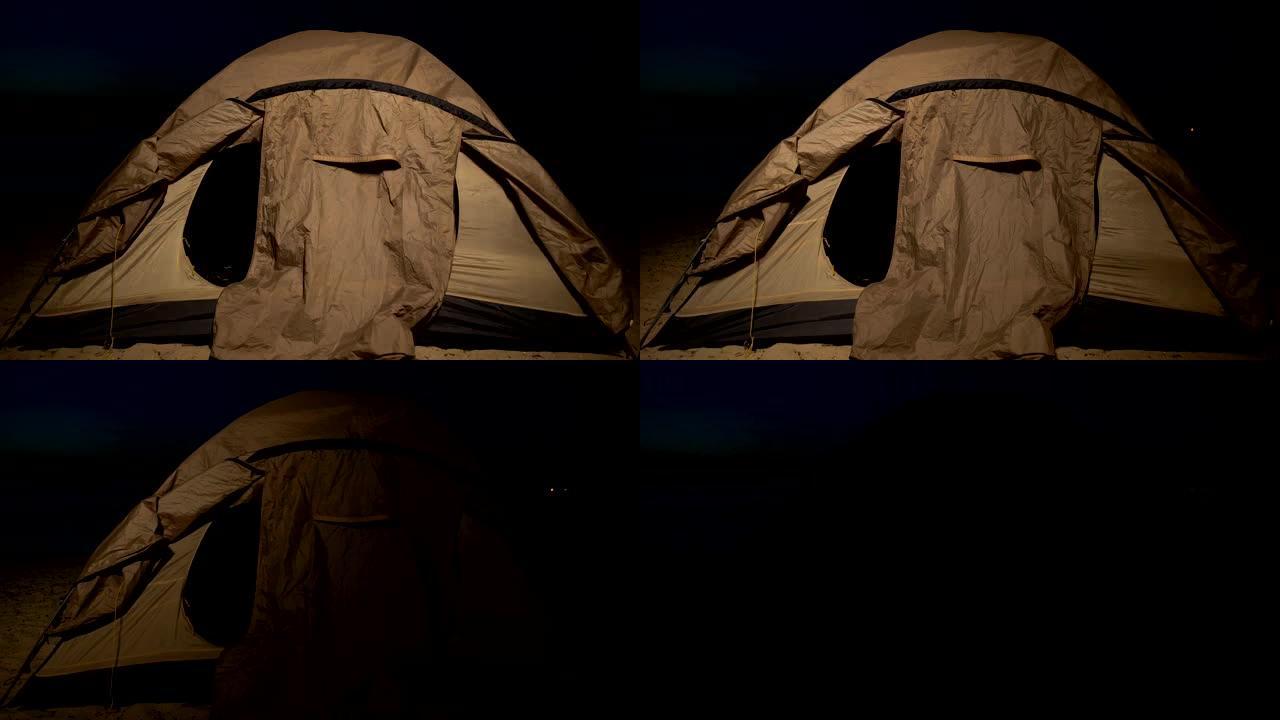 海岸警卫队的灯光显示了靠近海边的难民帐篷，非法移民营地