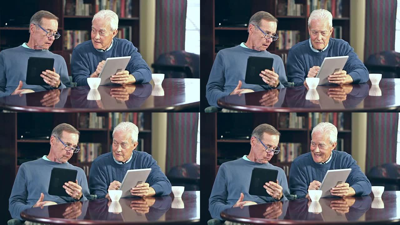 两名高级男子正在使用数字平板电脑交谈