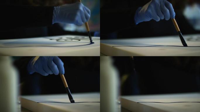一位60多岁的女性高加索艺术家用画笔将油画涂在画布上的俯仰镜头