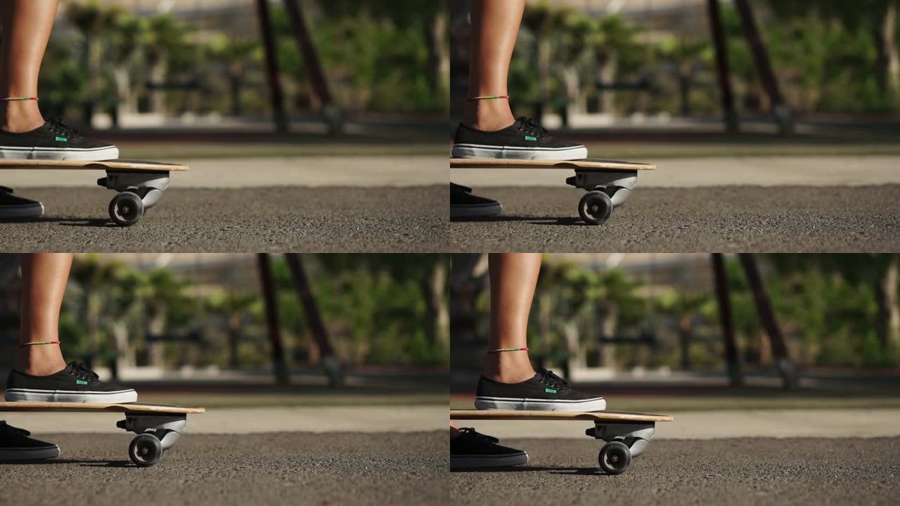 脚踩在滑板上并推离地面的特写镜头。滑板上路