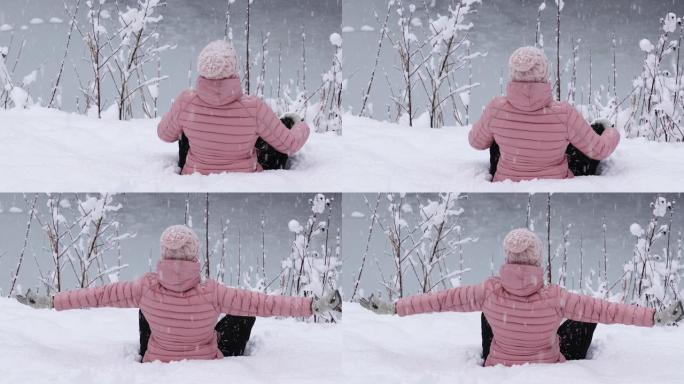 女人看着雪花落在白雪皑皑的森林里