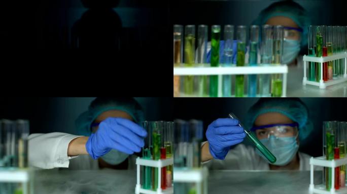 研究人员打开冰箱并分析管中蓝色透明液体