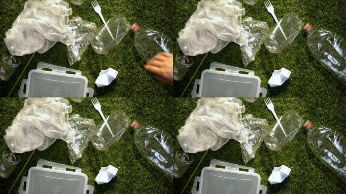 手扔塑料杯靠近其他垃圾，不负责任的行为，污染