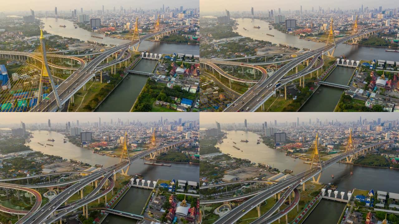 普密蓬悬索桥的俯视鸟瞰图穿越曼谷市的湄南河，汽车在泰国曼谷日落天空和云的桥上行驶。