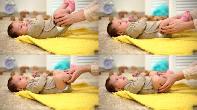 女士按摩婴儿腿，预防大腿关节发育不良，减轻绞痛
