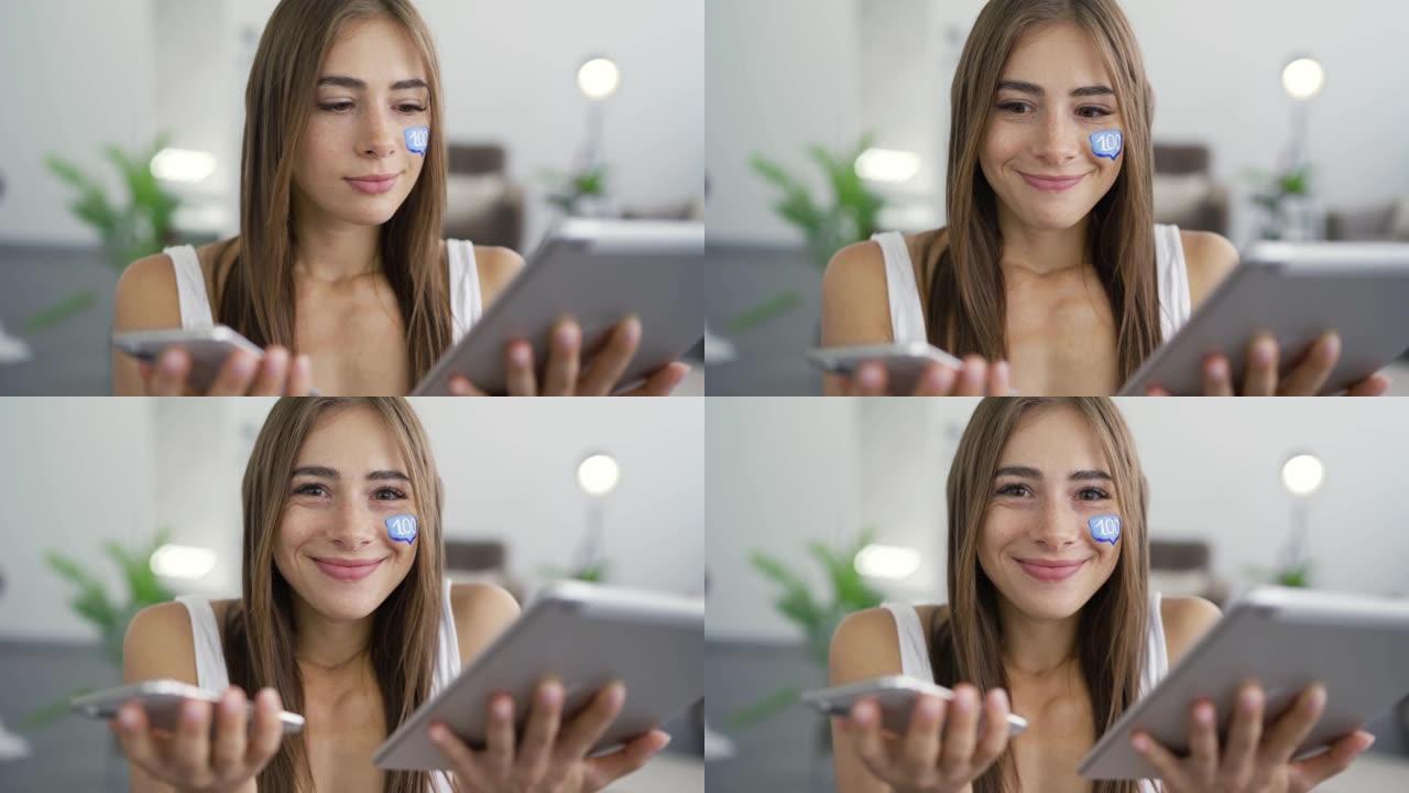 年轻迷人的女子肖像与彩绘短信框在她的脸上持有手机和平板电脑