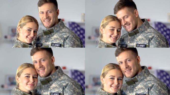 快乐的年轻军人和女人看着相机，军人夫妇，美国军队
