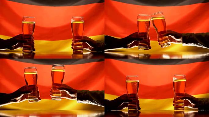 男性体育迷在酒吧里碰碰啤酒杯，背景是德国国旗，假日