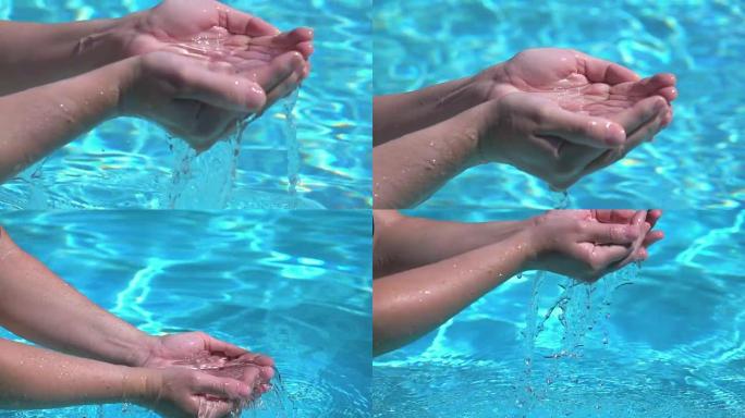 两个视频的手在真实的慢动作中画水