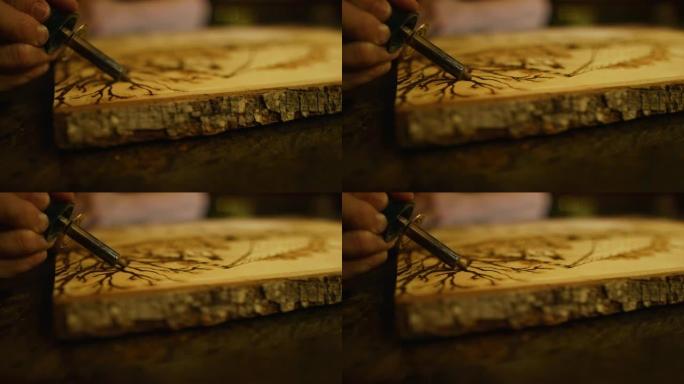 艺术家使用木材燃烧笔将设计燃烧成木材横截面的特写镜头