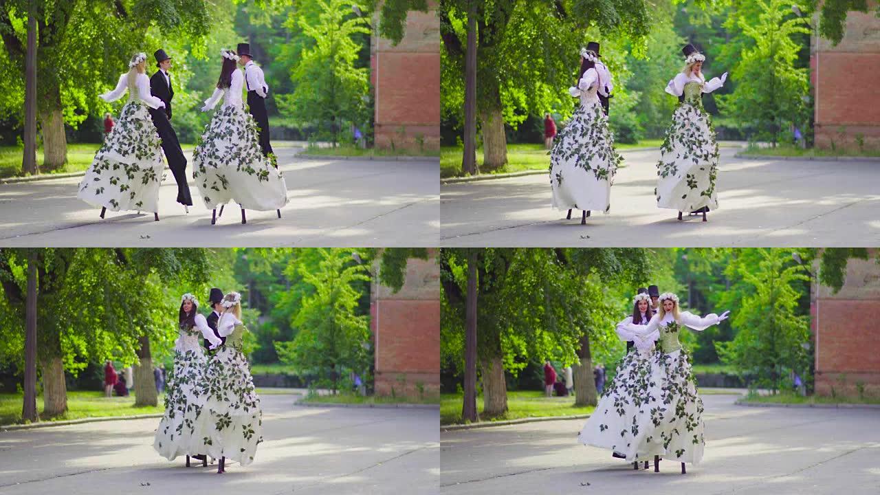 两对高跷的美女夫妇在街上跳舞