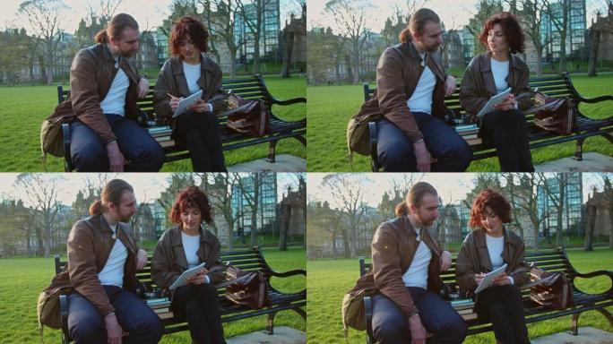 男人和女人在爱丁堡的公园里讨论和做笔记