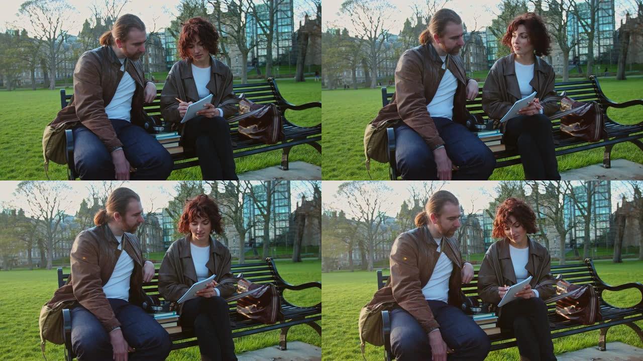 男人和女人在爱丁堡的公园里讨论和做笔记