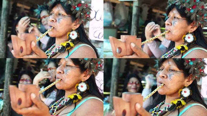 来自瓜拉尼族的巴西土著妇女吸烟烟斗