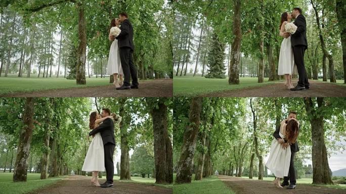 SLO MO DS新婚夫妇在公园跳舞并接吻