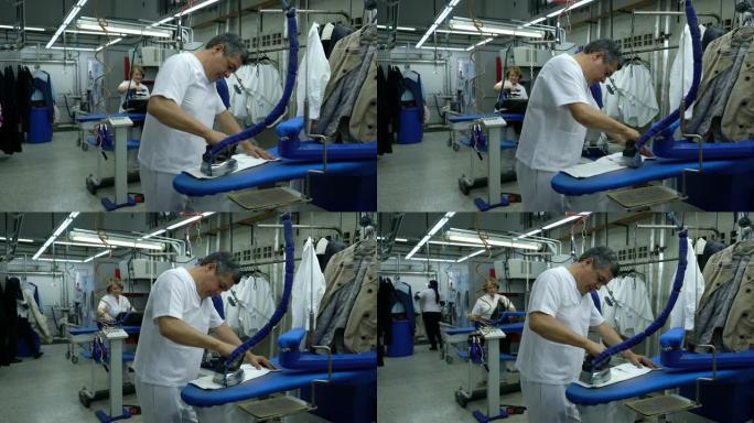 拉丁美洲的成年雇员在工业洗衣服务熨烫衣服