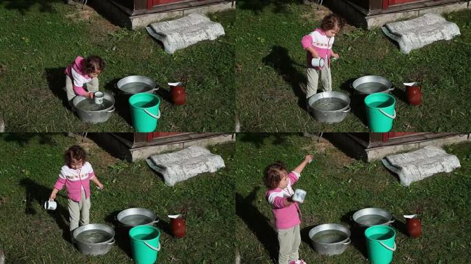 儿童从后院的盆中捞水