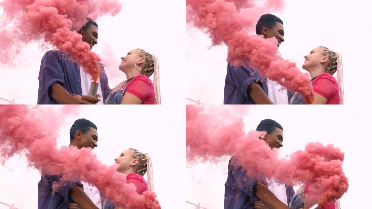 年轻的多民族夫妇拥抱在粉红色的烟雾，浪漫，慢动作中