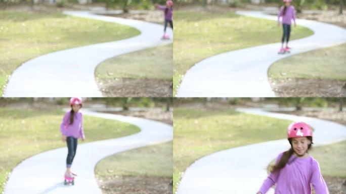 女孩在公园里朝摄像机骑滑板