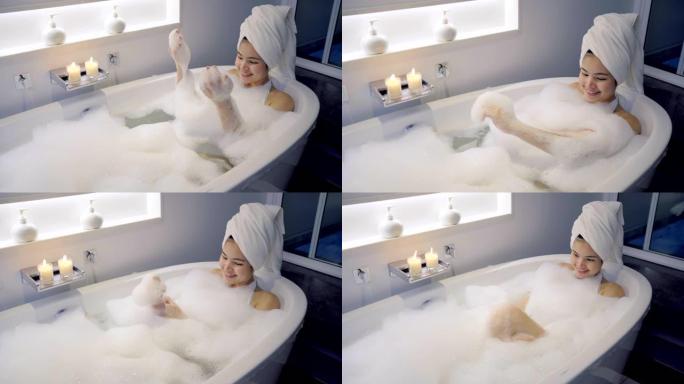 4k镜头特写女性在浴缸里洗澡玩泡泡。