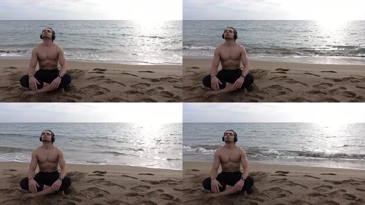英俊的男人独自在海滩上休息