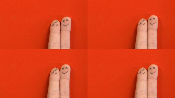恋爱中的手指脸夫妇在红色背景上孤立，团结概念