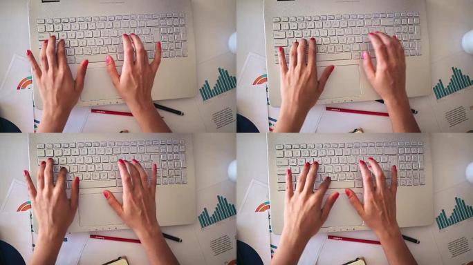 女性手打字笔记本电脑键盘，顶视图