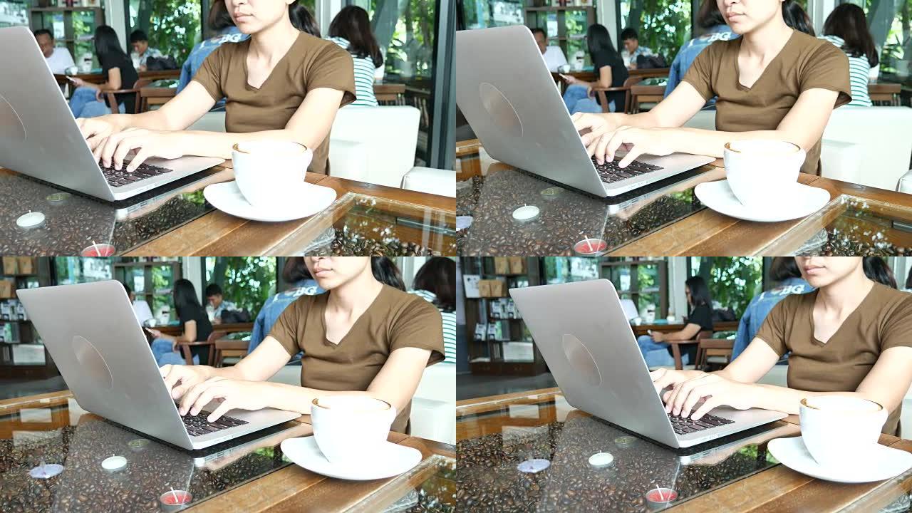 多莉射击动作: 女人在咖啡馆的笔记本电脑键盘上打字