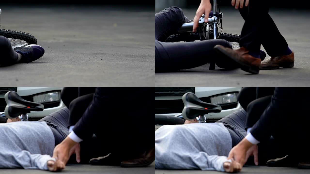 年轻男子检查手腕脉搏的女自行车躺在柏油路上失去意识