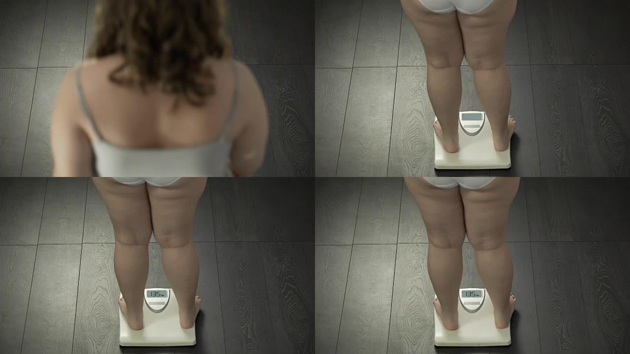 女人节食后踩在体重秤上，看到理想的体重，目标点