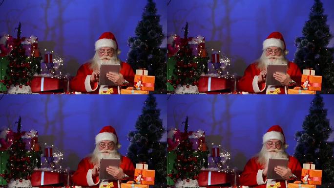 圣诞老人在数字平板电脑上工作