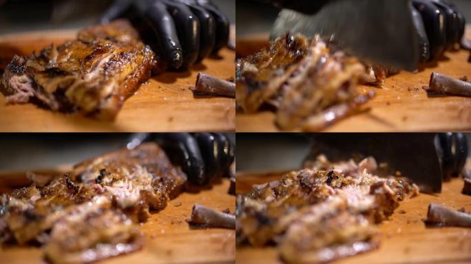厨师在优雅的木桌上切碎刚煮熟的多汁香煎排骨的肉。