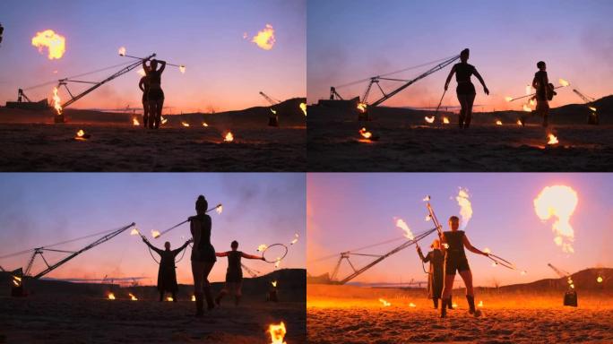 专业艺术家在夏季的沙滩上慢动作表演了一场火表演。马戏团的第四人杂技演员晚上在海滩上用火。