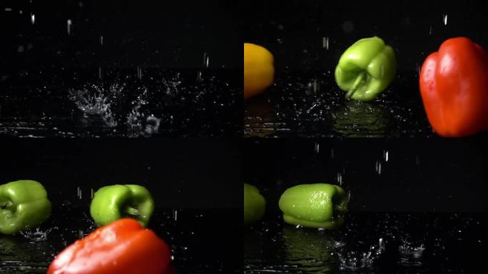 湿甜椒落在黑色背景上