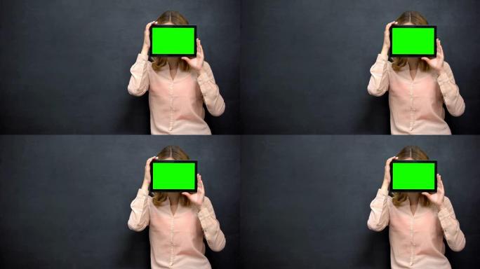 女孩把脸藏在绿屏后面，网上匿名的概念，模版