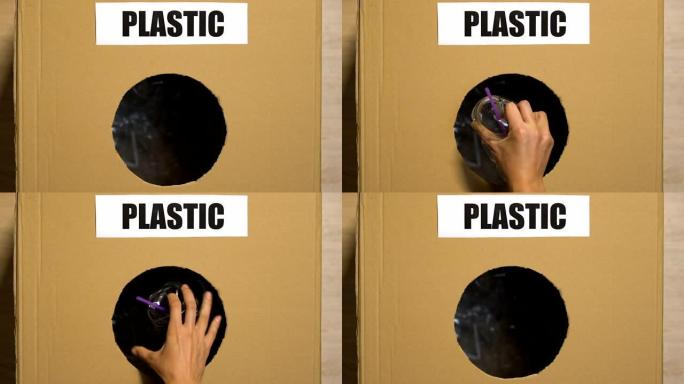 手工将一次性杯子放在带有塑料标志的废物篮中，分拣中心