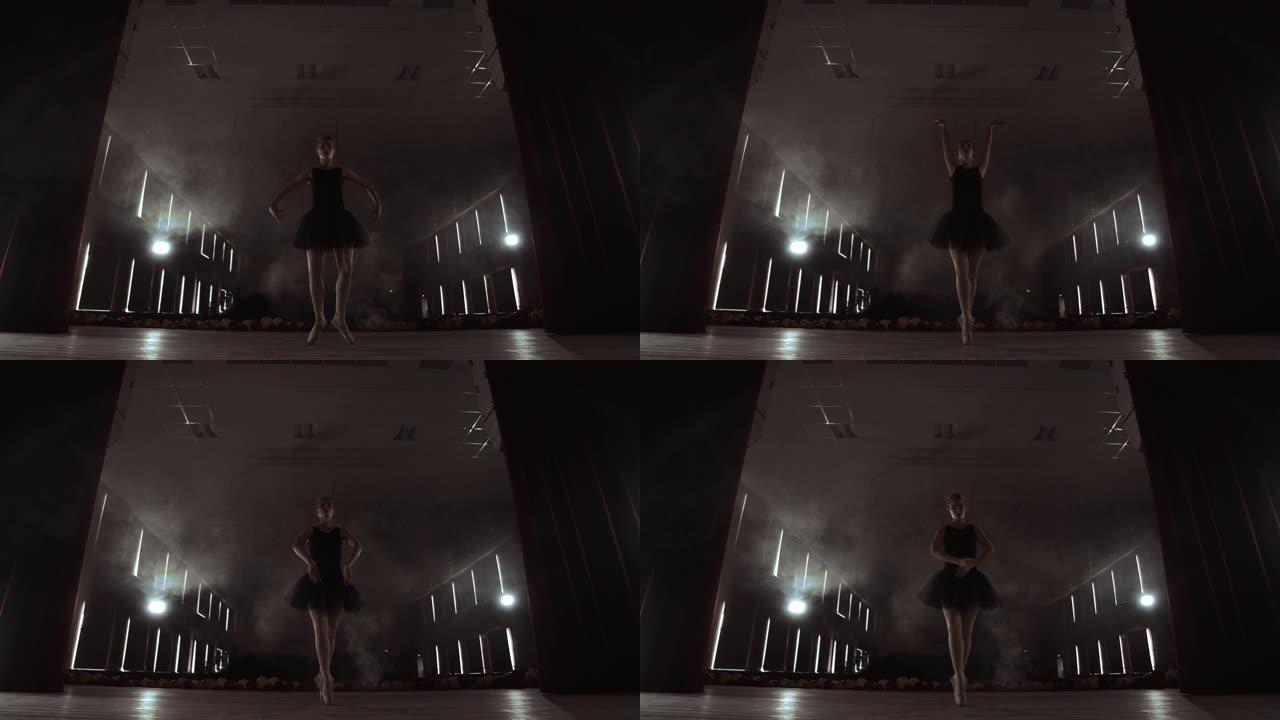 芭蕾舞女演员正在黑暗的工作室练习动作。年轻女孩穿着空气白色连衣裙芭蕾舞短裙跳舞，旋转着微笑。每一个动