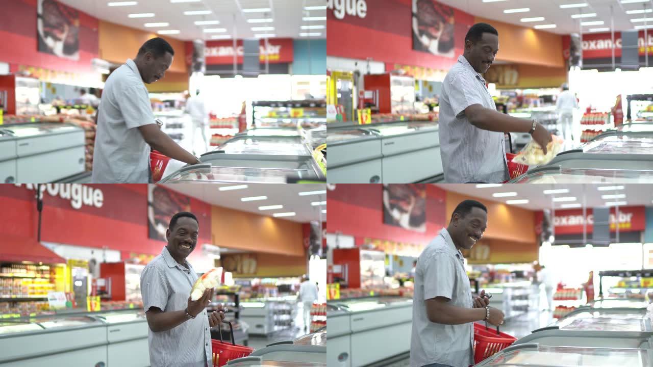 成熟的男人在超市冰柜中寻找和选择产品