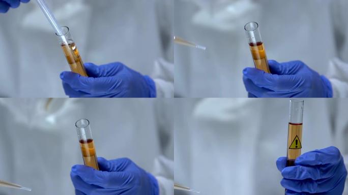 保护制服的化学家从试管中提取有毒液体样品，危险
