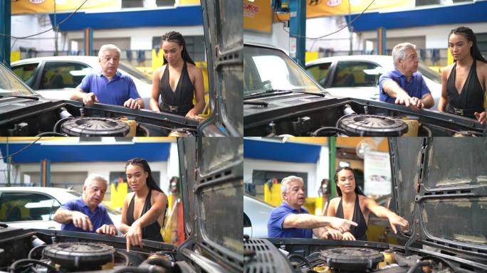 高级机械师向客户展示汽车修理厂