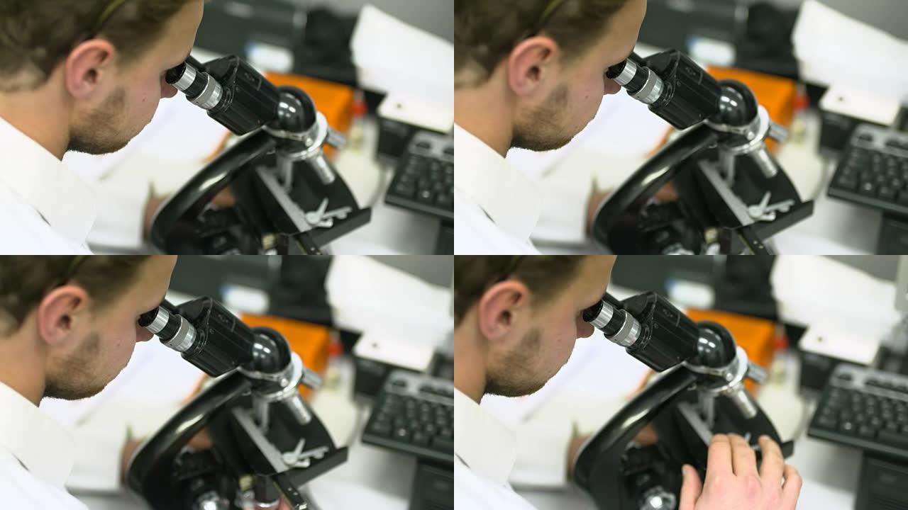 科学家正在通过显微镜观察并在平板电脑上写入数据。
