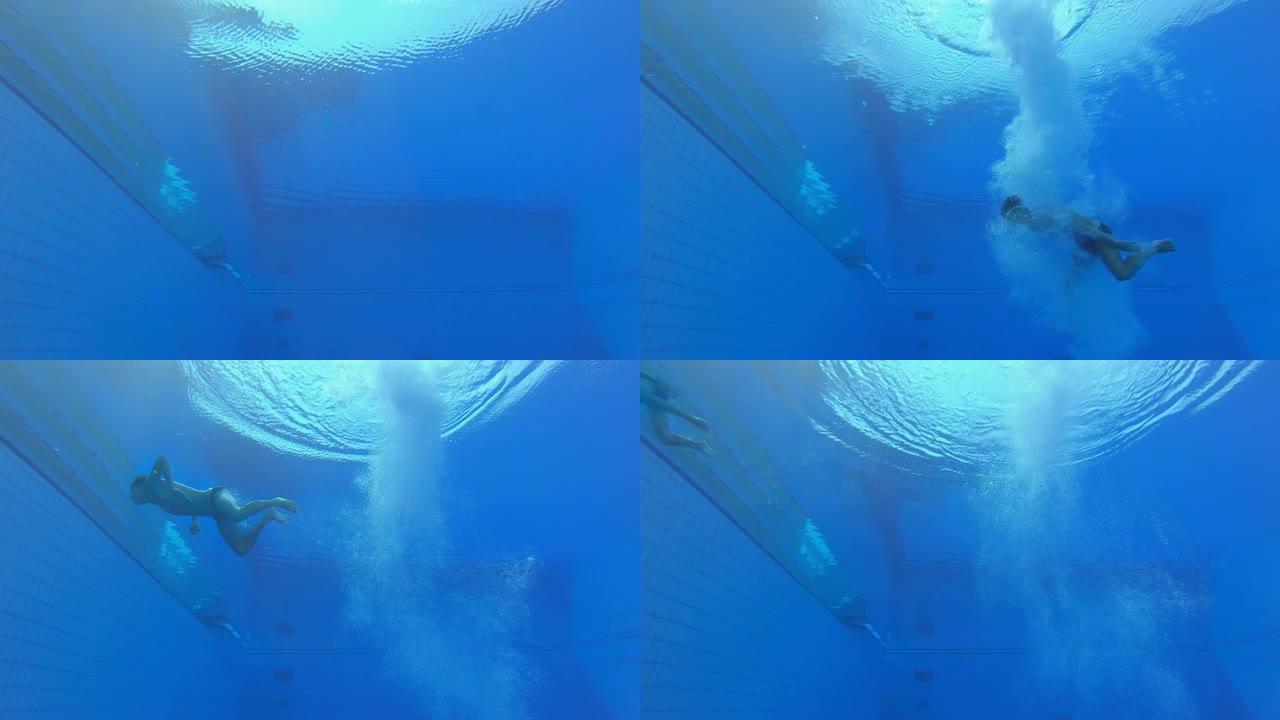 LD男潜水员降落在游泳池中，并在水下向水面游泳
