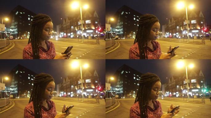 晚上，年轻女子在街角发短信